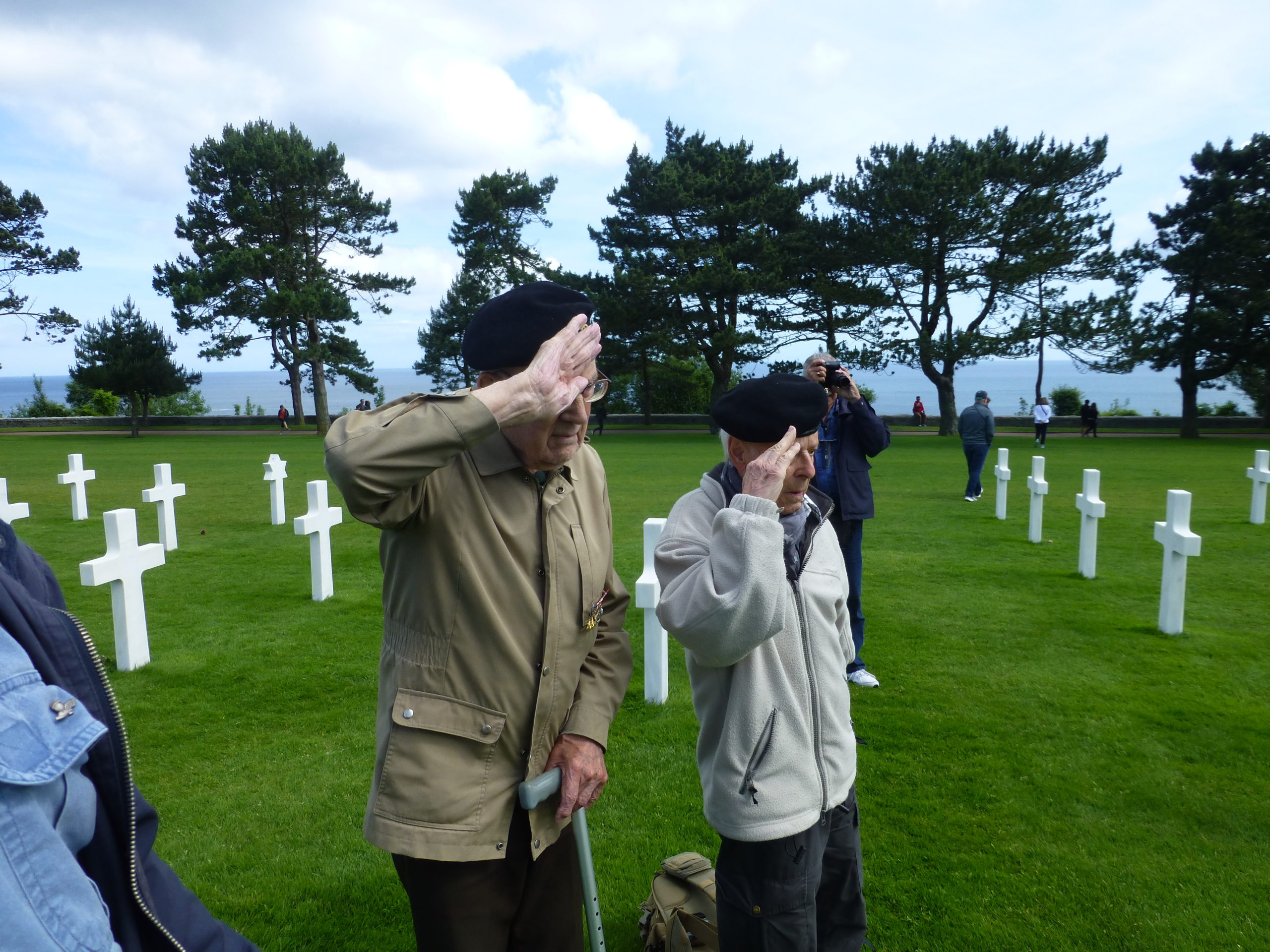 Graham Stevenson, Sherwood Rangers Tank Regiment, and Charley Koenig, Panzer Regiment 5, salute American war dead in Normandy